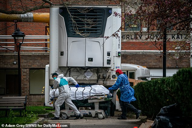 27056968-8209885-image-a-55_1586573236339 Bodies are moved to and from refrigerated morgue trailers at Kingsbrook Jewish Medical Center, Brooklyn