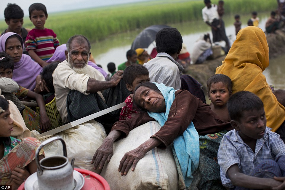 The images offer an important window into what is effectively a part of Myanmar that is largely sealed off to the outside world (pictured refugees waiting to be be moved into refugee camps near Palong Khali, Bangladesh)