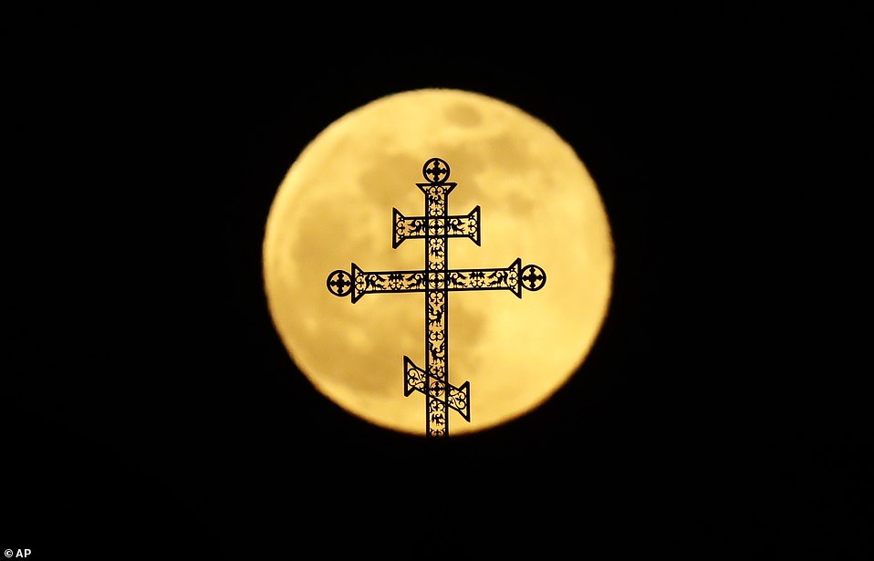 10011104-6724033-the_full_moon_rises_behind_a_steeple_with_crosses_of_an_orthodox-a-1_1550649900862 The full moon rises behind a steeple with crosses of an Orthodox church in Minsk, Belarus, last night. The phenomenon of 'supermoon' occurs when the moon is at its closest point to the earth making it appear larger than usual