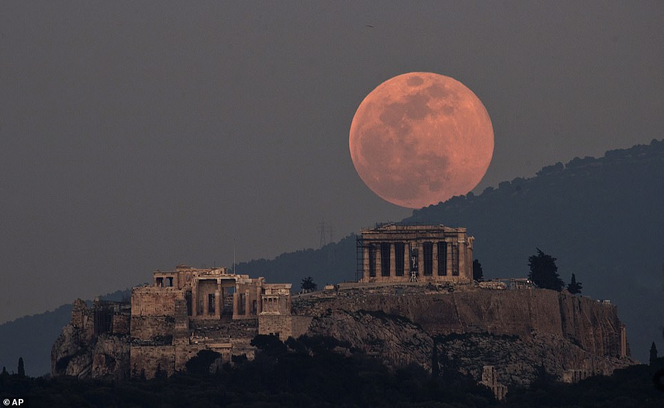 10012216-6721945-image-a-62_1550601481085 The moon rises over the Parthenon on the ancient Acropolis Hill in Athens, Greece on the second evening of its appearance (Tuesday)