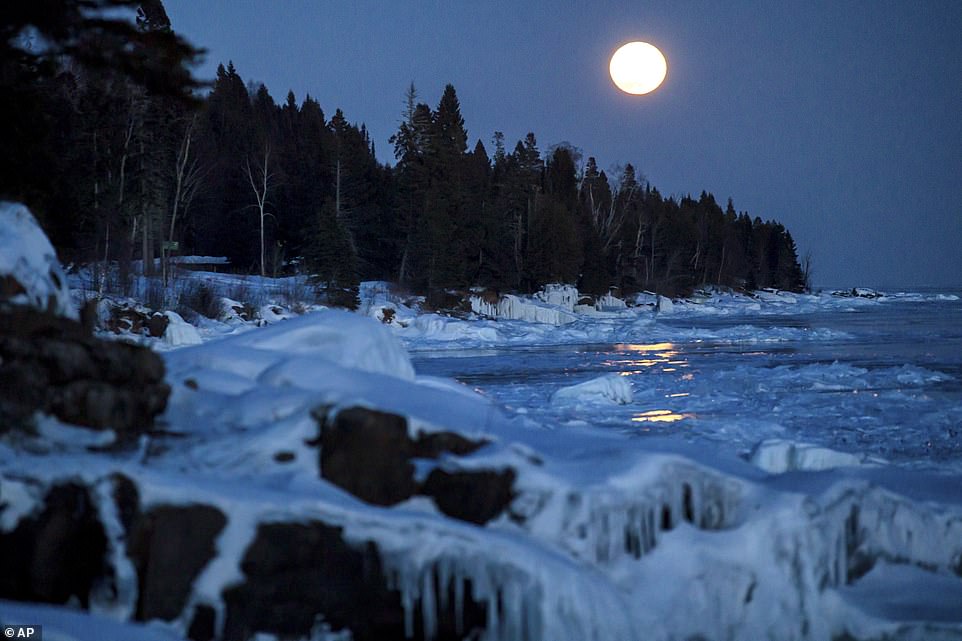 10032272-6723727-image-a-9_1550642591858 Tuesday's 'snow super moon'Â was the second in a trilogy of supermoons. A super moon rises over the ice on the shore of Lake Superior, in Lutsen, Minnesota on February 19