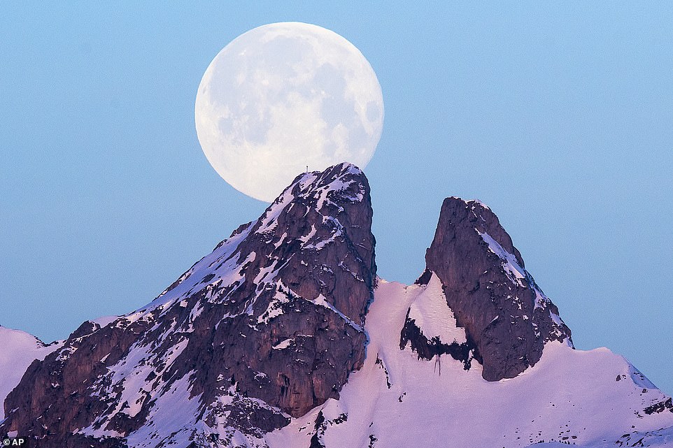 10036796-6724033-image-a-22_1550653643361 The moon sets behind the Les Jumelles Mountains in Plambuit, Switzerland. The name Super Snow Moon refers to the fact that its appearance often coincides with with heavy snowfall around this time of year