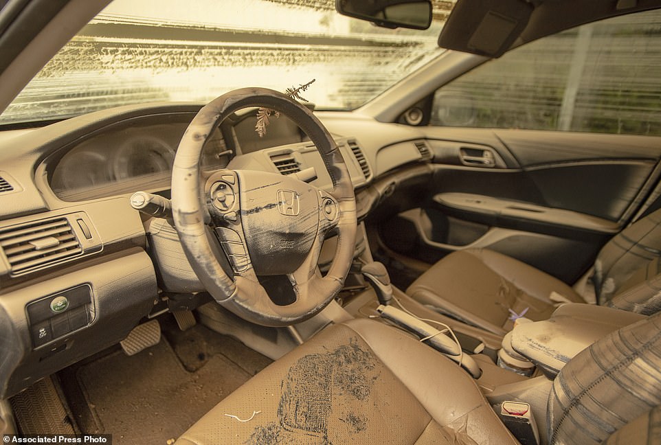 A coating of mud is left on the inside of a car that was underwater after days of heavy rain left towns reachable only by boat