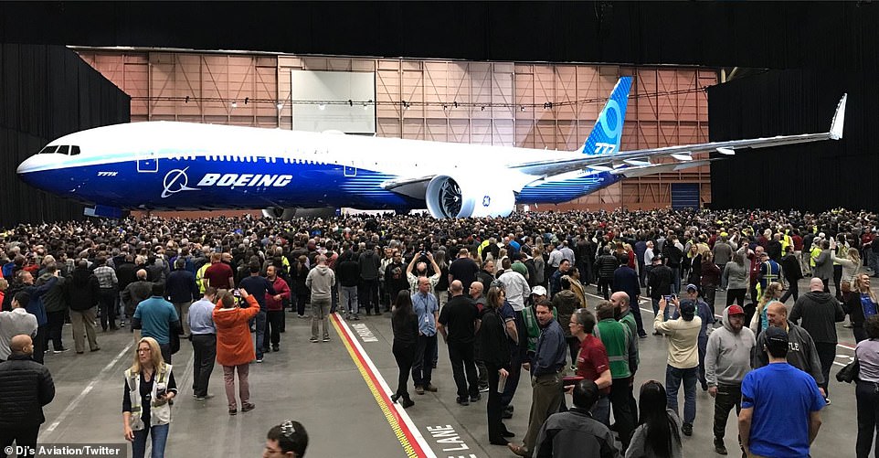 11029844-6813311-image-a-30_1552651789100 Boeing employees gather around the first fully assembled 777X aircraft at the plane manufacturer's plant near Seattle. The jet was unveiled at a low key ceremony attended by Boeing staff only