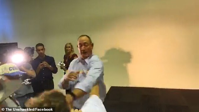 11064204-6816145-image-a-18_1552713957861 The man then slams an egg on to the back of the Senator's head who spins his body and takes a swipe at the youngster