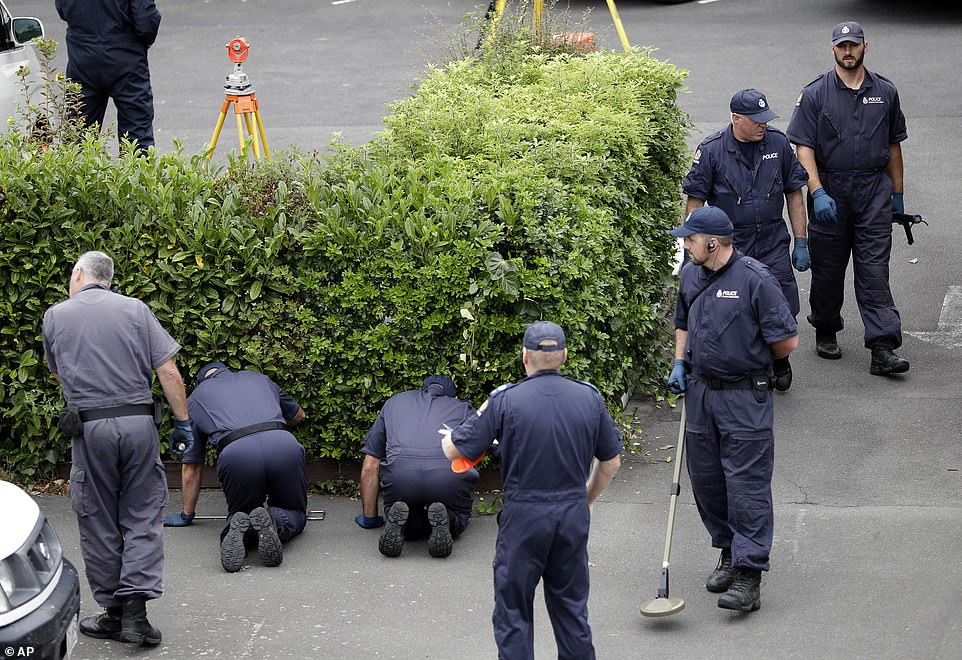 11066790-6815593-image-a-6_1552721852705 The investigation is ongoing as police are seen scouring the shrubbery of a motel near the Al Noor Mosque in Christchurch