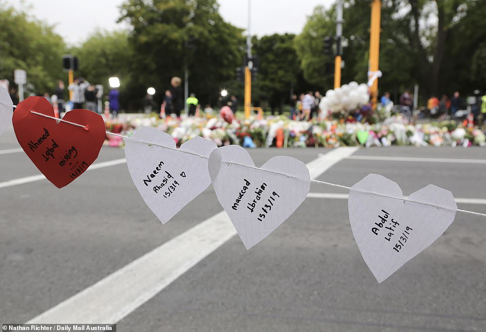 11066870-6815593-image-a-14_1552722233796 Relatives and friends write names of victims of the massacre on paper hearts and string them along the street of Christchurch