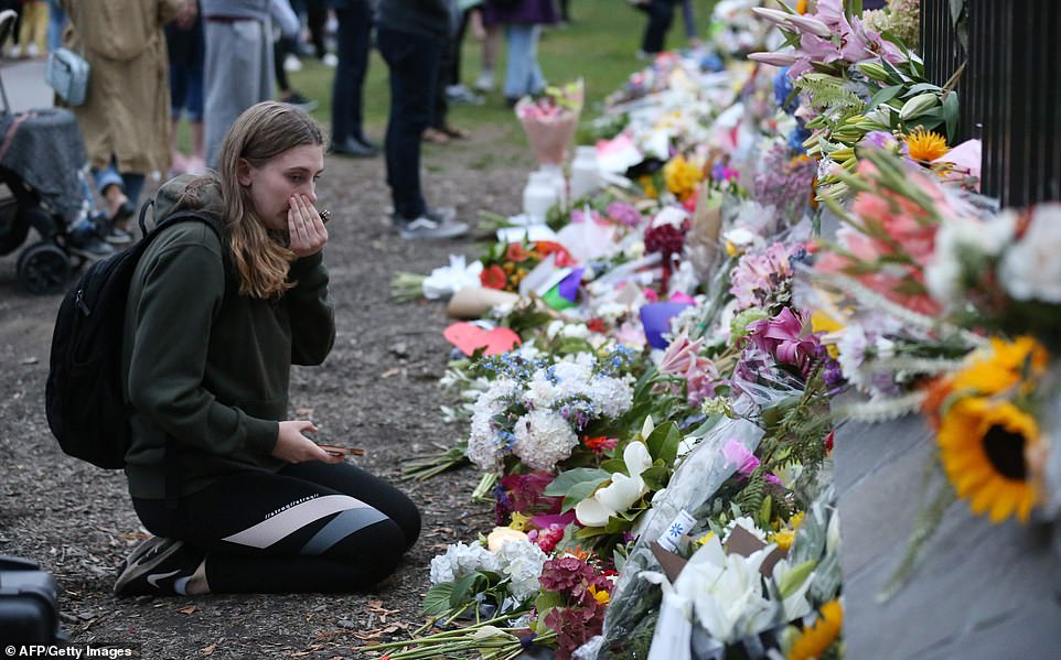 11066982-6815593-image-a-17_1552722470076 People pay their respect with floral tributes for victims of the mosque attacks. Vigils were underway across New Zealand