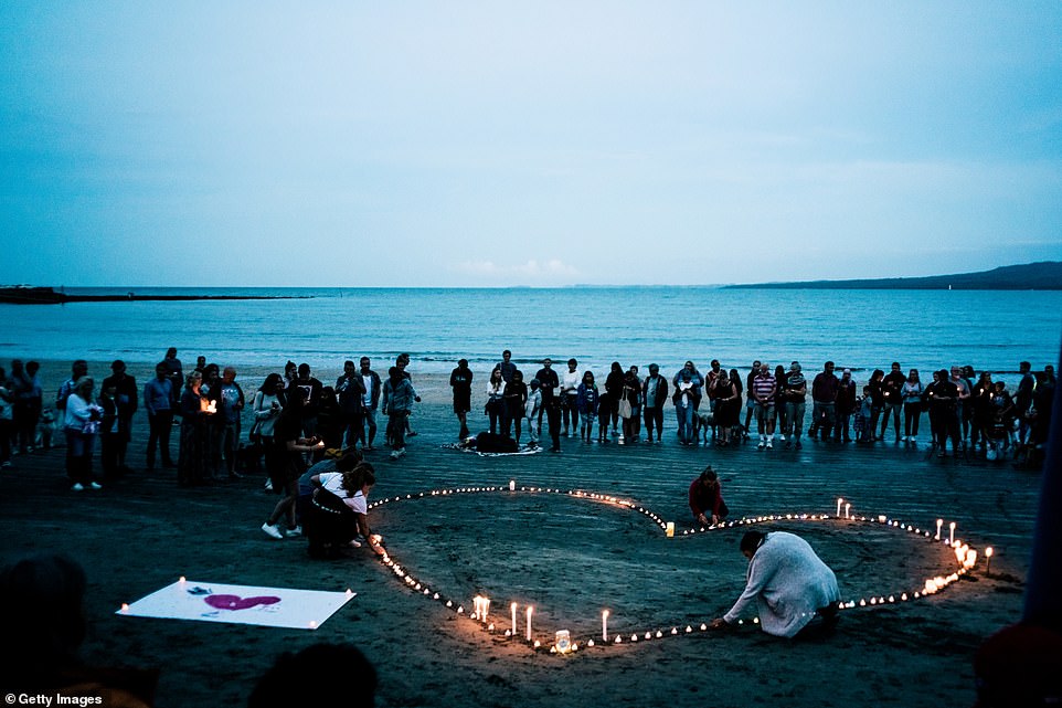 11072160-6816249-image-a-25_1552737604295 Crowds of mourners have gathered for a vigil in memory of the victims on Takapuna Beach in Auckland