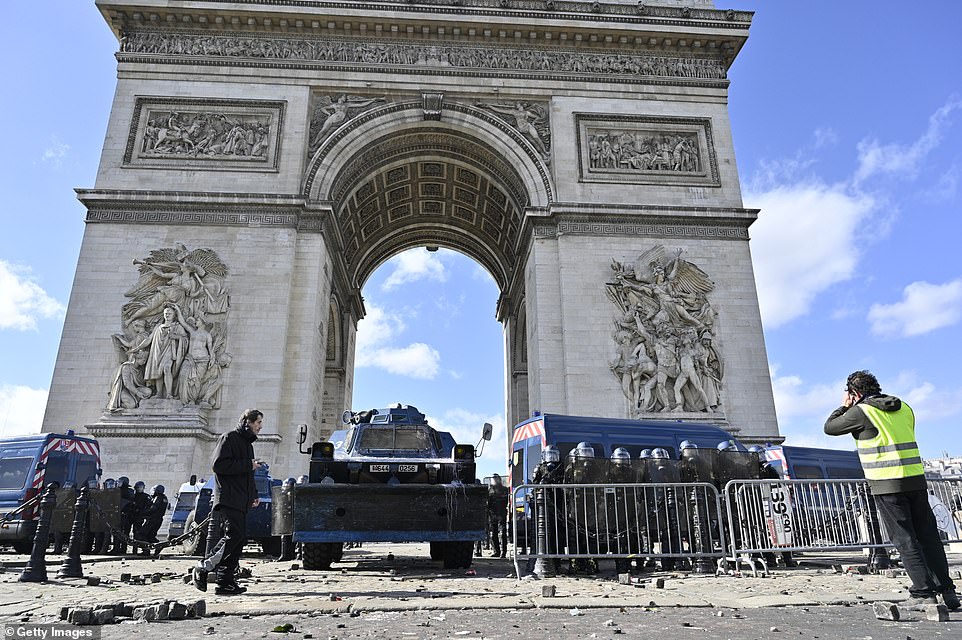 11077784-6816815-image-a-73_1552752026301 Security forces stand guard as yellow vests protesters stage a demonstration on avenue Champs Elysees in Paris, France
