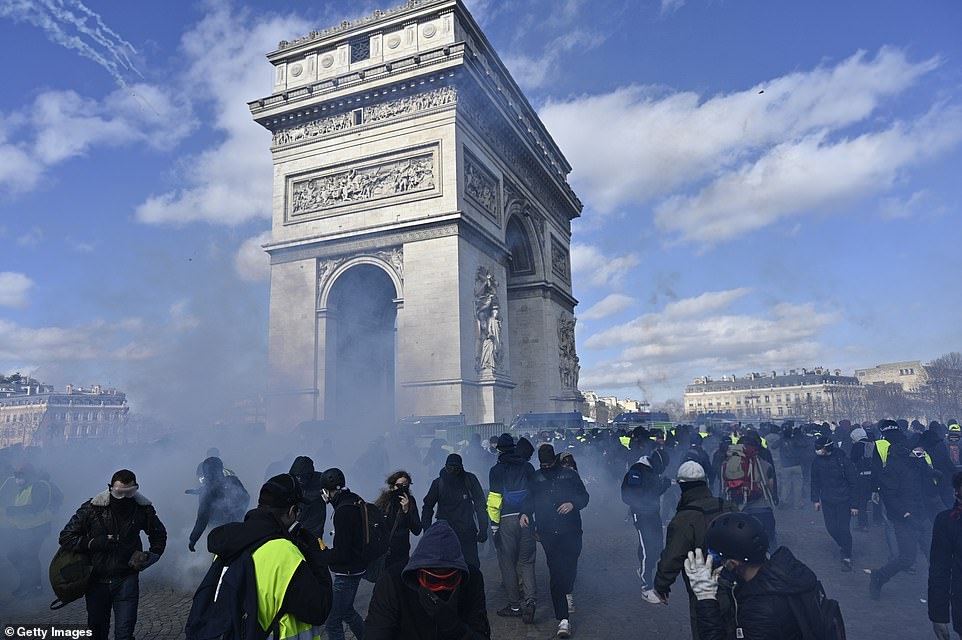11077832-6816815-image-a-57_1552751941787 Security forces intervene yellow vest protesters with tear gas during a demonstration on avenue Champs Elysees in Paris