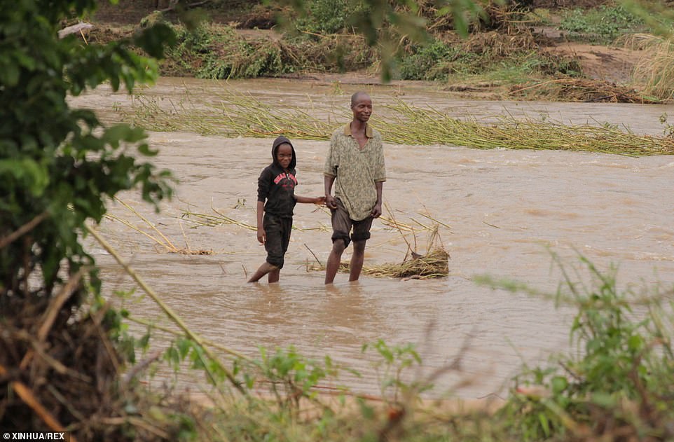 11142914-6822597-people_walk_through_a_flooded_river_in_chimanimani_zimbabwe_afte-a-9_1552931810491 People walk through a flooded river in Chimanimani, Zimbabwe, after the cylone moved inland
