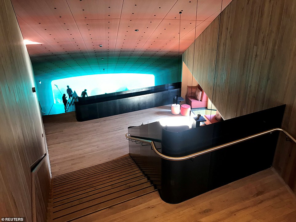 11225654-6829411-image-a-45_1553083939658 An eight-metre flight of stairs leads down to a large dining area that sits about 40 guests, walled by a gigantic transparent window to the sea