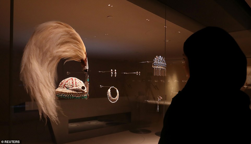 11557126-6846189-image-a-20_1553763430032 Fascinating: A woman looks at a royal crown on display at the National Museum