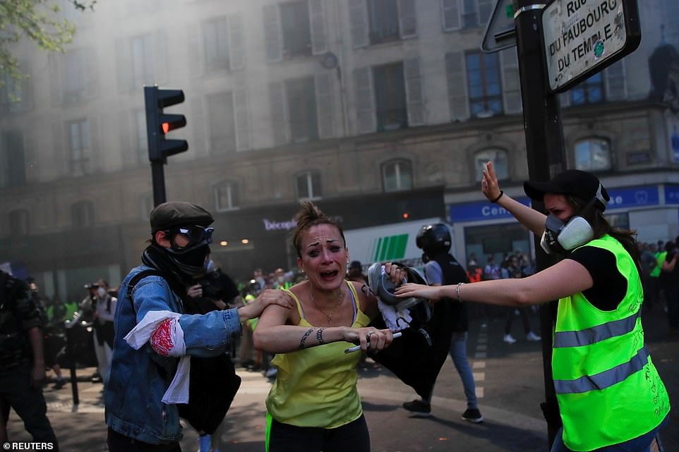 A protester reacts to the scenes at a demonstration today, which is the 23rd consecutive national protest, in Paris, France