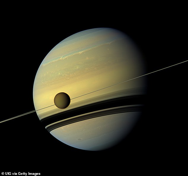 12975360-6982425-image-a-18_1556745337767 Cassini helped to gather information on Titan (shown in front of Saturn) having orbited Saturn 13 times throughout its life