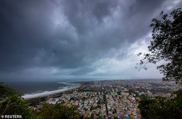13038558-6988125-image-a-10_1556868310577 Looming disaster: Menacing clouds hang above Visakhapatnam, India, on Thursday ahead of the storm's landfall on Friday morning
