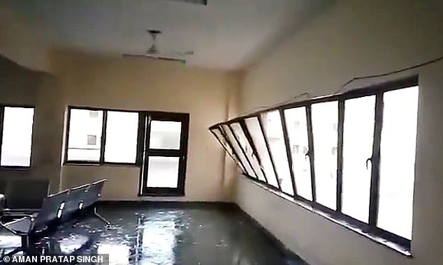 13042390-6988125-image-m-31_1556874950477 Bent out of shape: A glass window is blown out of its frame at a building in Bhubaneswar as Cyclone Fani makes landfall on Friday