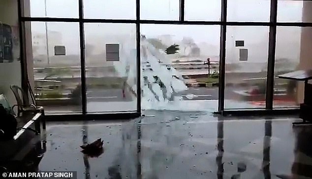13042392-6988125-image-a-29_1556874936724 Shattered: A glass door smashes during Cyclone Fani in Bhubaneswar as authorities evacuate the homes of a million people amid fears of a storm surge