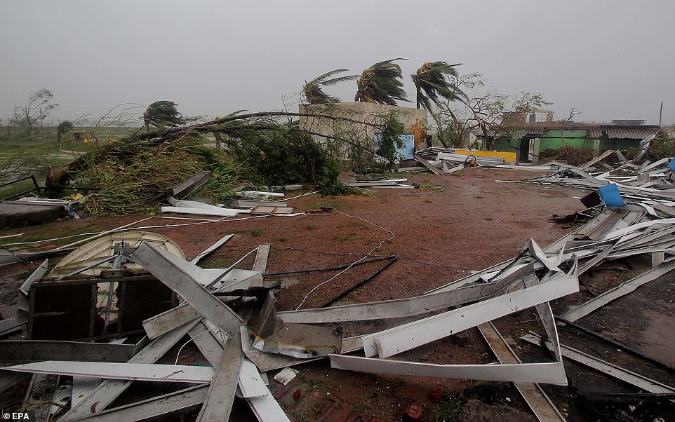 13049880-6988125-image-a-18_1556891734787 Wreckage: Debris from a destroyed petrol station roof lies on the ground in Konark, on India's east coast where the storm hit