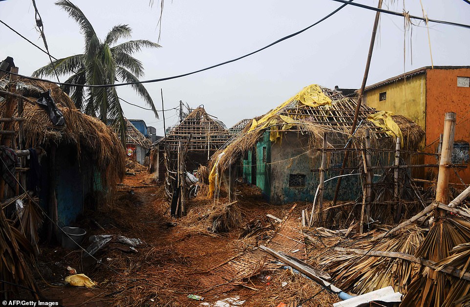 13077754-6991719-image-a-4_1556954485249 Damaged homes are pictured near the seafront in Puri in the eastern Indian state of Odisha today following the Cyclone
