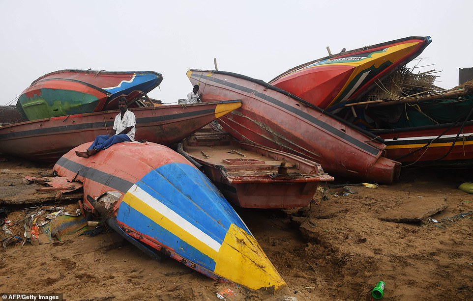 13077760-6991719-an_indian_man_sits_on_a_damaged_fishing_boat_along_the_seafront_-a-81_1556955581729 An Indian man sits on a damaged fishing boat along the seafront in Puri in the eastern Indian state of Odisha, many fishermen will have lost their livelihoods following the destruction