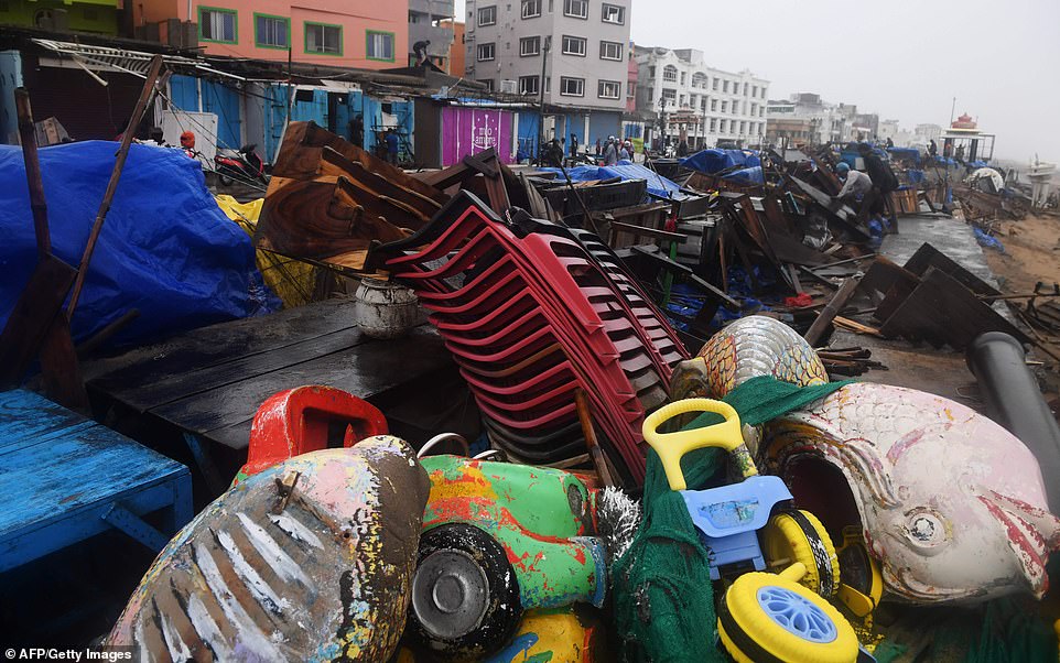 13078008-6991719-image-a-51_1556954779422 Indian residents inspect damages on street stalls at a promenade after Cyclone Fani landfall in Puri in the eastern Indian state of Odisha on Friday