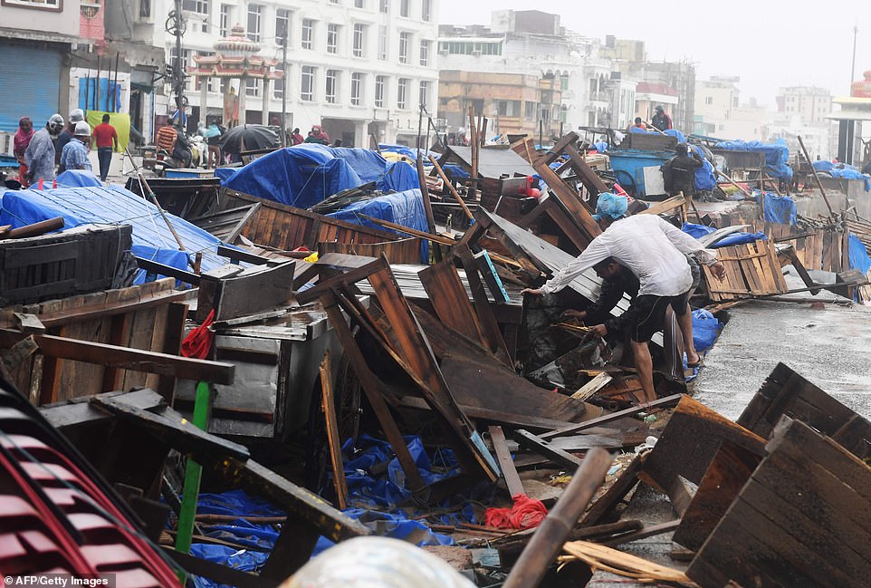 13078016-6991719-image-a-60_1556954868410 Indian residents inspect damages on street stalls at a promenade after Cyclone Fani landfall in Puri in the eastern Indian state of Odisha on May 3