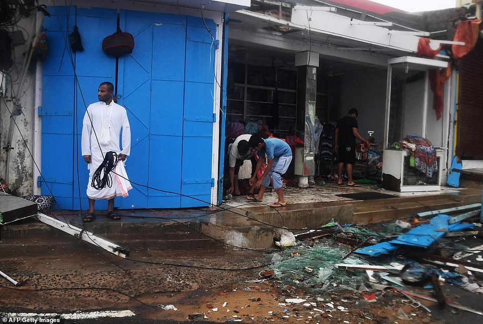13078020-6991719-image-a-62_1556954872112 Indian residents inspect the damage and clear debris after Cyclone Fani landafall in Puri in the eastern Indian state of Odisha on May 3