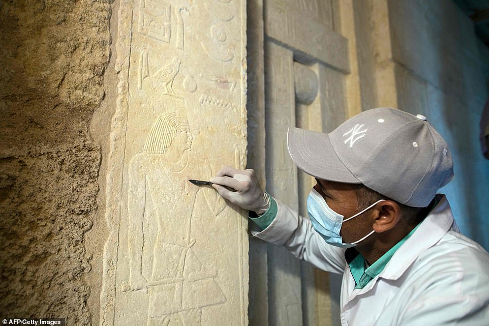 13086260-6992141-image-a-13_1556984467004 An excavation worker carefully uses a tool inside a burial shaft at the Giza pyramid plateau following the recent discovery of the tombs