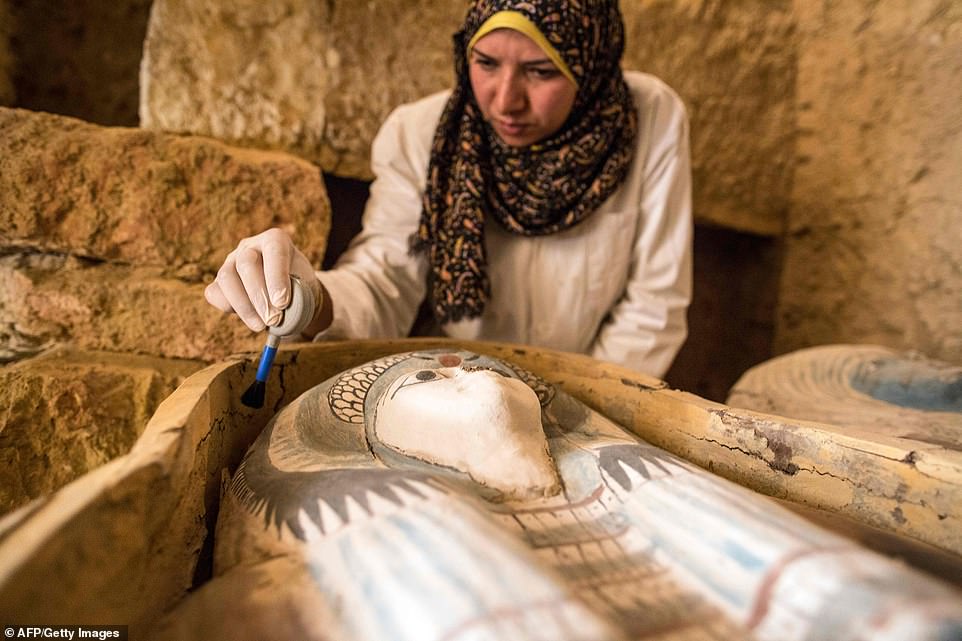 13086262-6992141-image-a-18_1556984487798 This excavation worker carefully brushes dust from the face of the sarcophagus