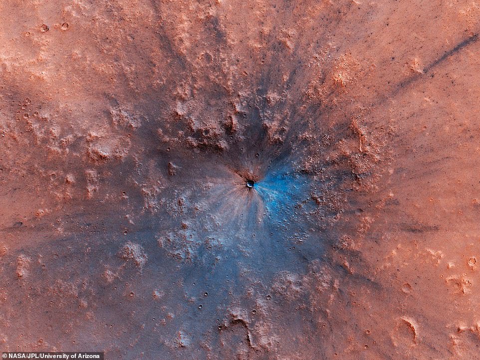 14911546-7151749-image-a-32_1560809797837 A 50-foot-wide impact crater has appeared on the surface of Mars. In a jaw-dropping photo captured by the High Resolution Imaging Science Experiment (HiRISE) instrument on NASA’s Mars Reconnaissance Orbiter, the new crater appears an explosive feature on the dusty surface