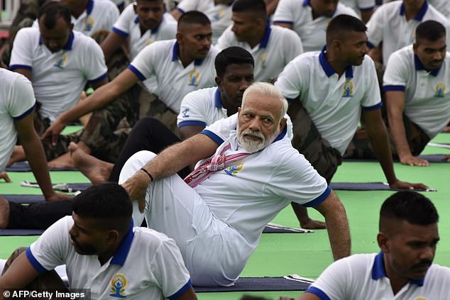 15105064-7169075-image-a-134_1561162809862 Yoga Day, observed mostly in India but also worldwide on the Northern Hemisphere's longest day, was the idea of Indian Prime Minister Modi, pictured yesterday during a mass yoga event