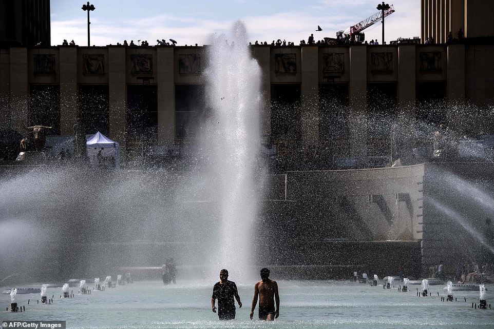 15221778-7178557-people_cool_themselves_down_in_a_pond_at_the_trocadero_esplanade-a-152_1561491059116 People cool themselves down in a pond at the Trocadero esplanade in Paris. A number of parks are being kept open later to allow people to cool down