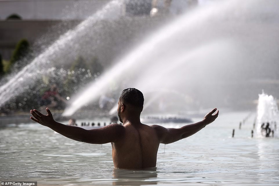 15221780-7178557-a_man_cools_himself_down_in_a_pond_at_the_trocadero_esplanade_in-a-189_1561491578165 A man cools himself down in a pond at the Trocadero esplanade in Paris where orange warnings are issued