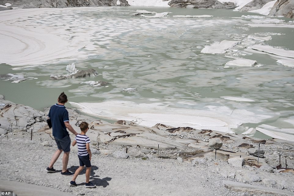 15235566-7178557-people_walk_around_a_lake_at_the_melting_rhone_glacier_in_furka_-a-136_1561491059100 People walk around a lake at the melting Rhone Glacier in Furka, Switzerland, which will also see high temperatures this week