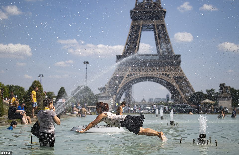 15239130-7178557-people_cool_down_in_a_fountain_in_the_trocadero_gardens_in_paris-a-130_1561491059097-2 People cool down in a fountain in the Trocadero gardens in Paris, across from the Eiffel Tower