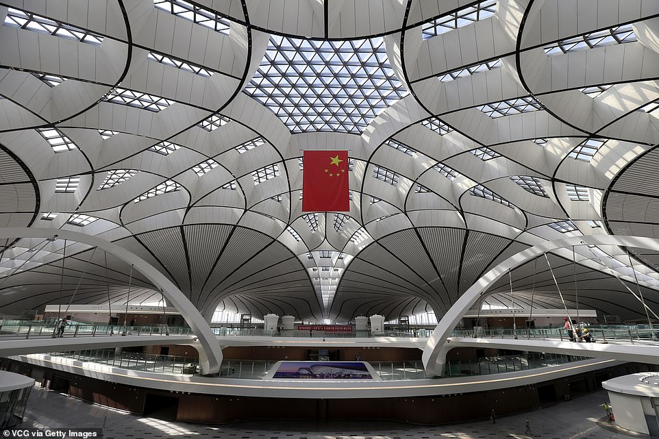 15479334-7200627-image-a-154_1561986586581 Inside, it stands out for its flowing, curved lines and use of light that filters down to the lowest levels of the building through openings in the roof. Underneath the terminal is a train station that will allow travellers to reach the city centre in 20 minutes