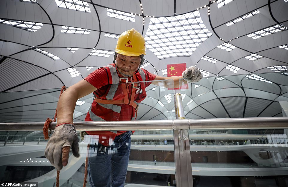 15479726-7200627-image-a-198_1561987033956 The airport, constructed with 1.6 million cubic metres of concrete and 52,000 tonnes of steel, cost 79.9 billion yuan (£9.2 billion) to build, according to People's Daily