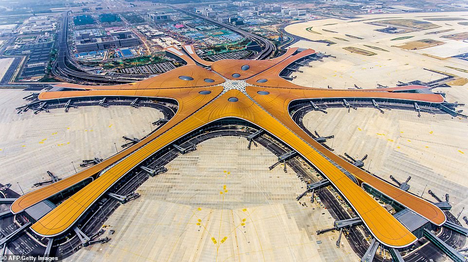 15479740-7200627-image-a-148_1561986548560 China has completed its new mega airport in Beijing after four years of construction, three months ahead of its planned grand opening. Measuring at 1.03 million square meters - about the size of 144 football pitches - the Beijing Daxing International Airport will be the world's largest airport terminal, according to Xinhua News