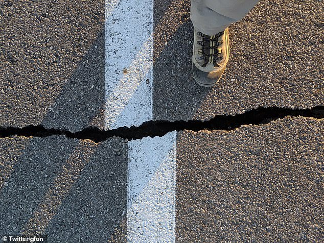 15677812-7216817-image-a-38_1562338943671 San Bernardino County authorities said the quake caused water mains to break, cracked buildings and caused rock slides on roads. Pictured: A road crack caused by the earthquake