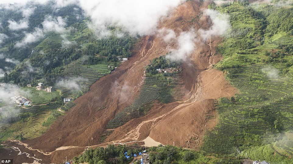 16430940-7279739-image-a-52_1563965262007-2 The above aerial photo taken today shows the landslide site in Pingdi Village in Shuicheng County of Liupanshui City, southwest China's Guizhou Province. A total of 21 houses in Pindi village were buried in rocks and mud last night at 9:20pm