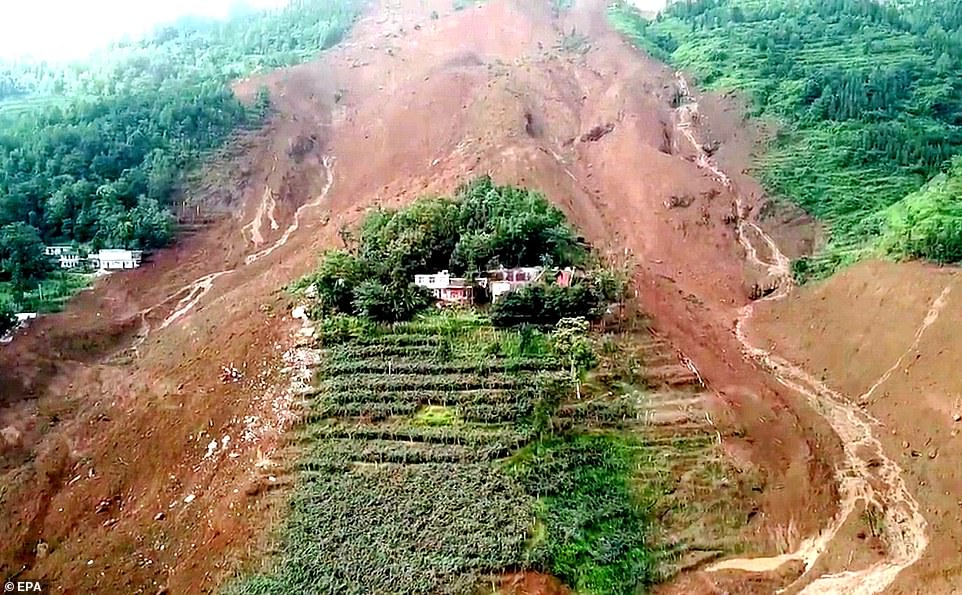 16430956-7279739-image-a-71_1563965604259 A total of 21 houses in the village were buried in rocks and mud following days of heavy rain, state media said