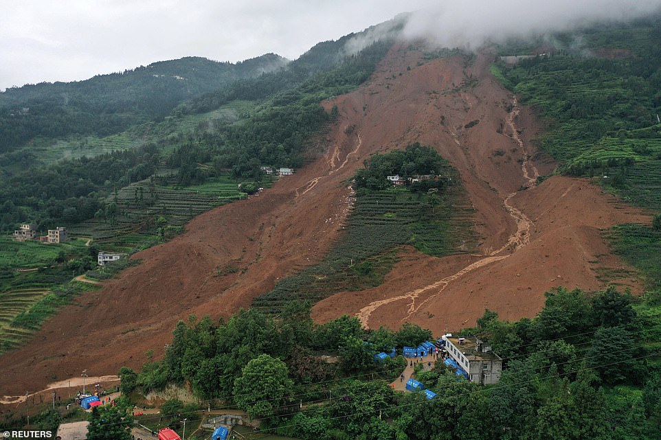16430970-7279739-image-a-59_1563965439470 Aerial images show the devastating aftermath of the rock slide as emergency crews work to find survivors at the site. Blue tents set up by the recovery teams are seen at the foot of the landslide that killed 11 people
