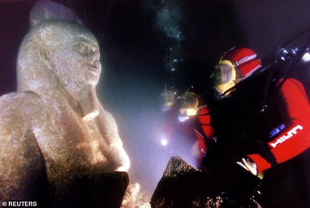 16448326-7281351-image-a-68_1563981257189-2 Secrets of the sea: Three divers inspect the ancient colossal statue of Hapi, the god of the Nile, at the site of the sunken city of Heracleion. Here, divers inspect a statue of the God Hapi off the coast of Alexandria