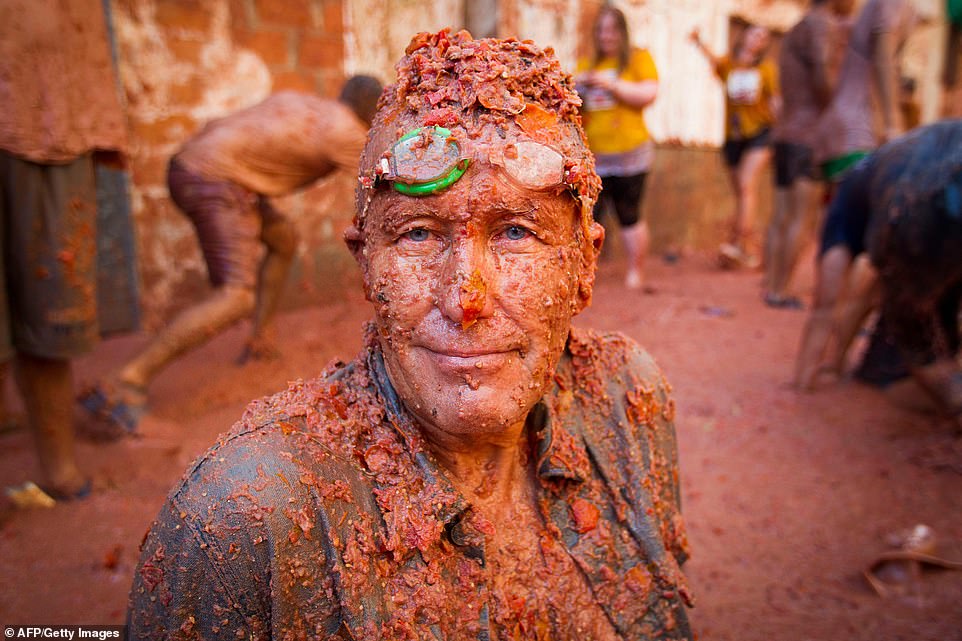 17792370-7403445-image-a-22_1567005324796 This man appeared completely at peace during the festival, despite having what looked like a pile of tomato pulp on top of his head and almost every inch of his face covered