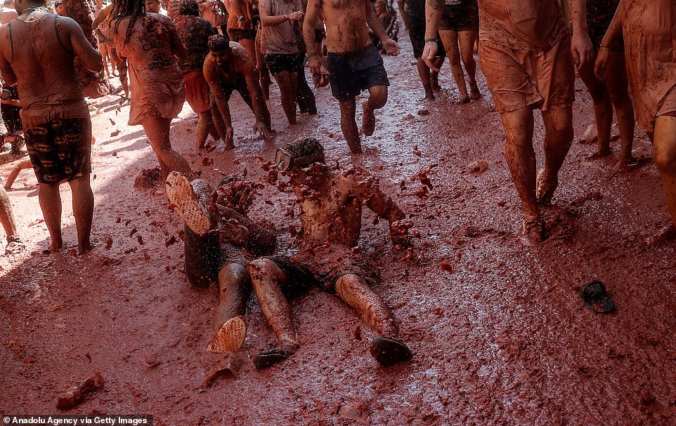 17792400-7403445-image-a-42_1567005393730 Every inch of the ground looked to be covered in tomato pulp during the today's festivals, with crews later hosing down the streets
