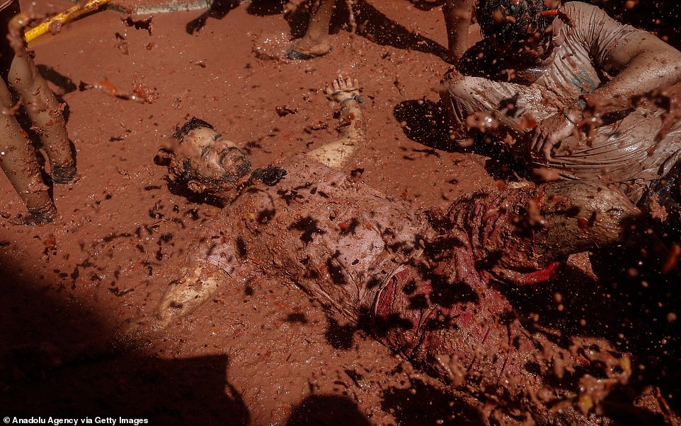 17792430-7403445-image-a-56_1567005444391 This reveller, completely covered in tomato pulp, takes part in the 74th "Tomatina" Festival in the eastern town of Bunol, Spain