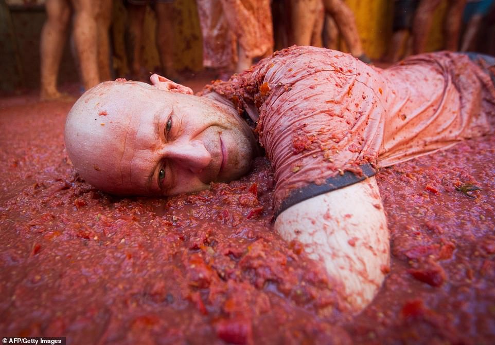 17792498-7403445-image-a-77_1567005551819 While this man appeared to have decided a street covered in tomatoes was the perfect place for him to lay down and catch up on sleep