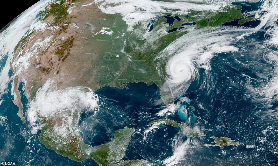 The satellite photo above shows Dorian's position over the Carolinas at noon on Thursday as rescue efforts continue across the region